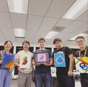 Five people pose for a photo while holding canvases of paintings and a laptop with AI art